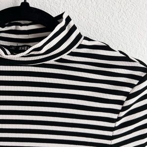 The perfect long sleeve with a bit of a turtleneck to layer or leave as is.